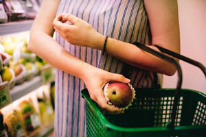apple in a woman hand with basket